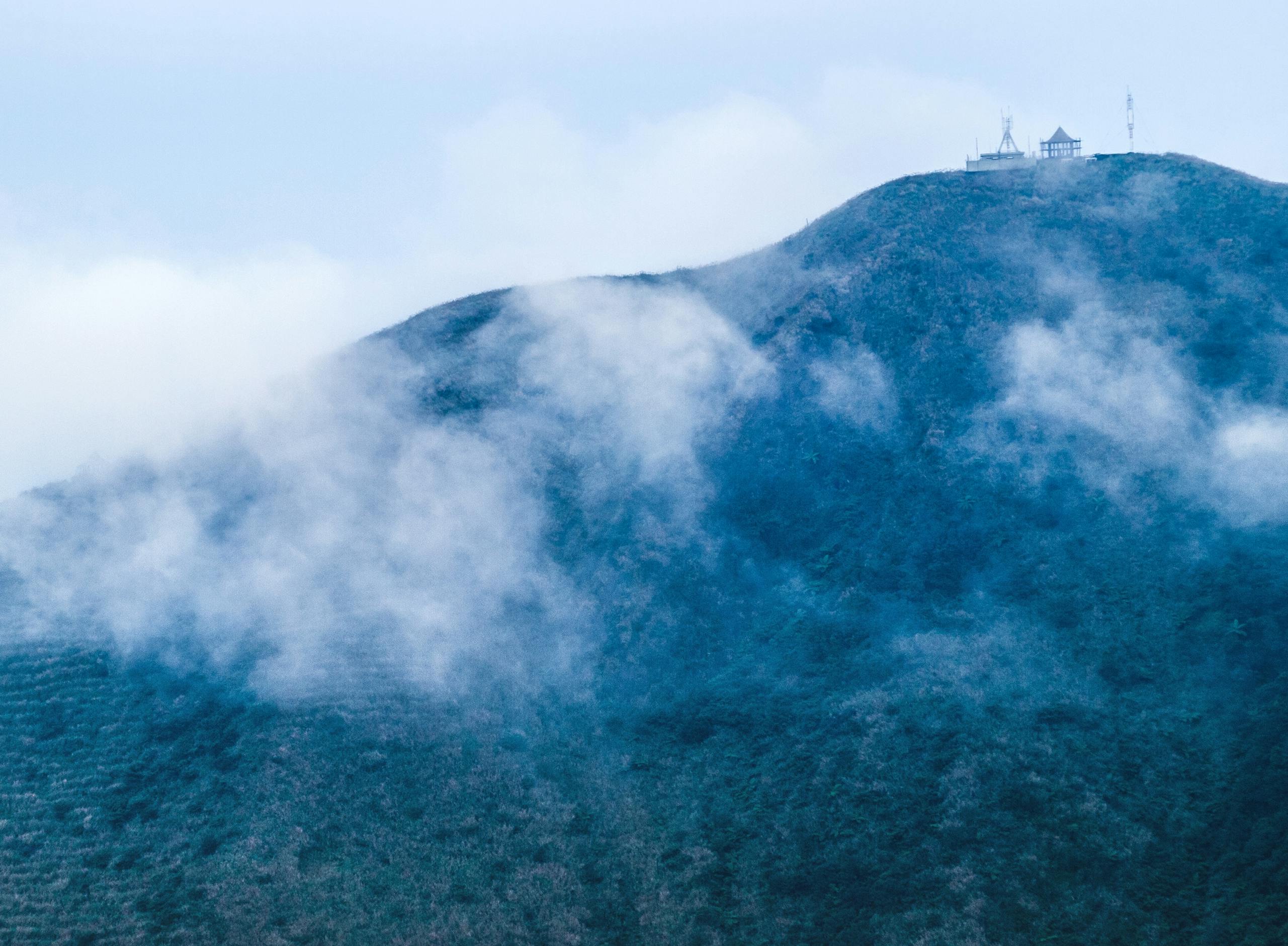 A misty mountain with a remote building in Taiwan, perfect for hiking enthusiasts.